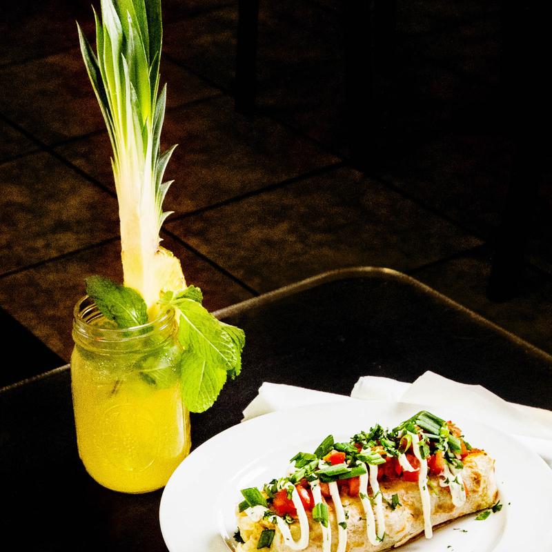 Ultimate breakfast burrito with pineapple mimosa